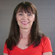 Smiling woman with long dark hair and bangs